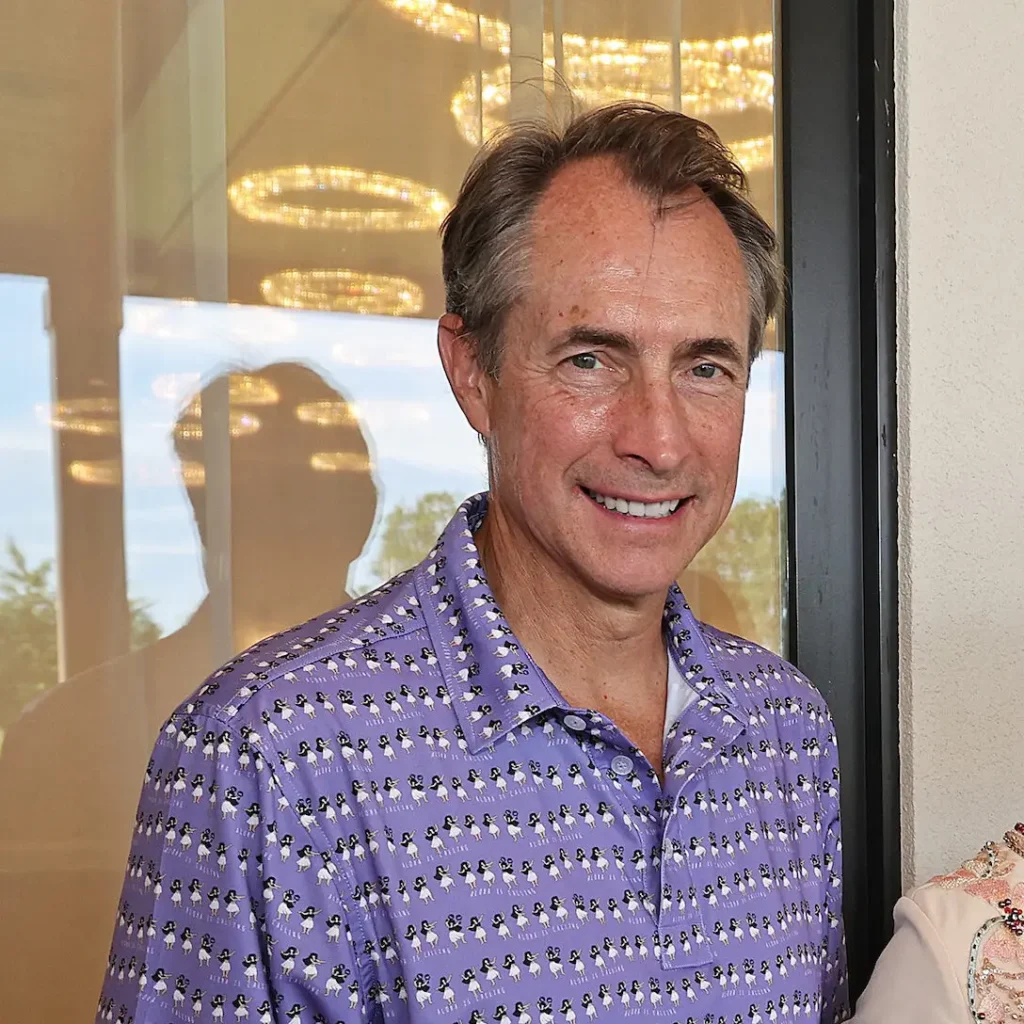 Man in purple polo shirt with penguin pattern