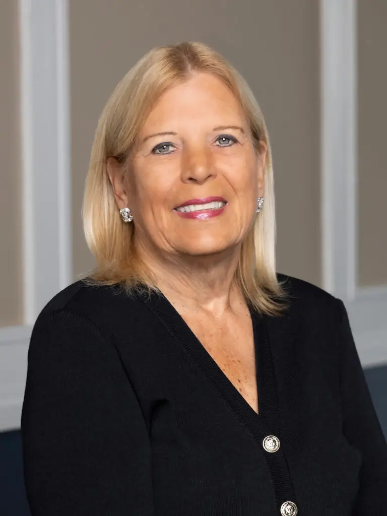 Image of a woman with blonde hair wearing a black top