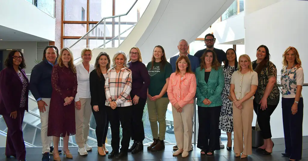 Group of professionals standing indoors.